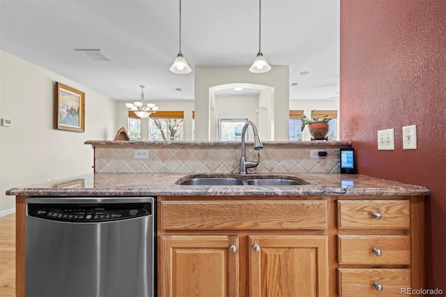 17808 E 104th Pl Unit C, Commerce City, CO 80022 - kitchen featuring stainless steel dishwasher, backsplash, light stone countertops, and hanging light fixtures