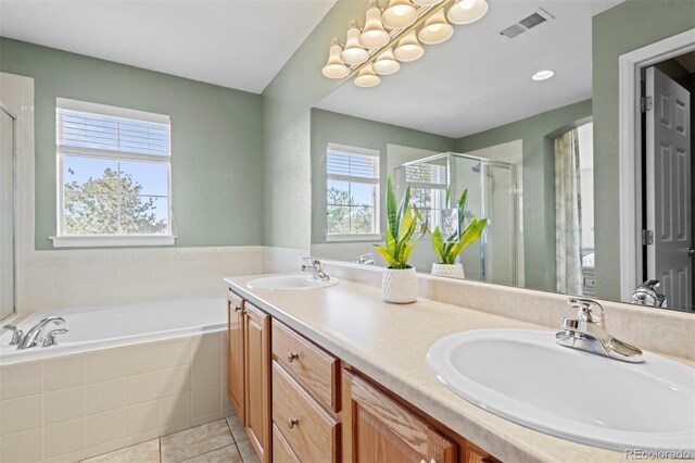 17808 E 104th Pl Unit C, Commerce City, CO 80022 - full bath featuring a stall shower, a garden tub, double vanity, and tile patterned floors