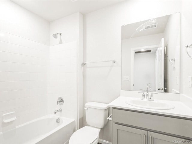 full bathroom with toilet, tiled shower / bath, and vanity