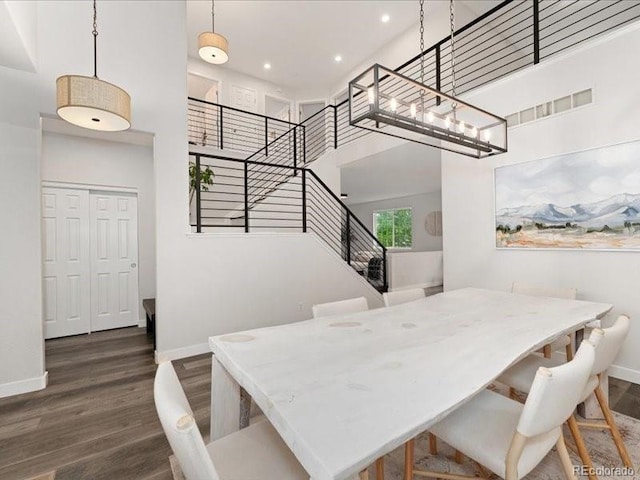 2833 Open Sky Way, Castle Rock, CO 80109 - dining space featuring baseboards, wood finished floors, recessed lighting, a towering ceiling, and stairway
