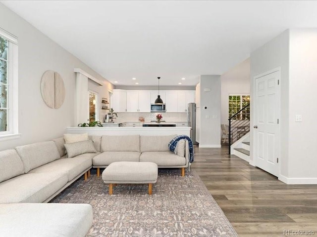 2833 Open Sky Way, Castle Rock, CO 80109 - living area with wood finished floors, recessed lighting, stairs, and baseboards