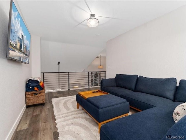 2833 Open Sky Way, Castle Rock, CO 80109 - living area with baseboards, wood finished floors, and vaulted ceiling