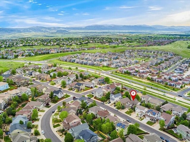 2833 Open Sky Way, Castle Rock, CO 80109 - aerial view of property's location featuring a mountain backdrop and nearby suburban area