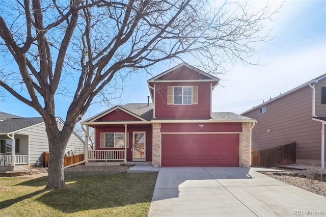 view of front of property featuring fence, driveway, covered porch, a front lawn, and a garage