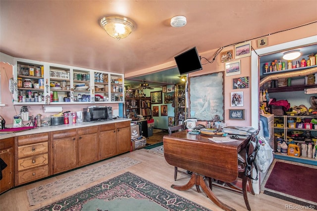 office space with ceiling fan and light hardwood / wood-style flooring