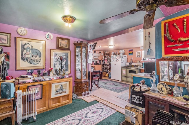 carpeted office space featuring ceiling fan