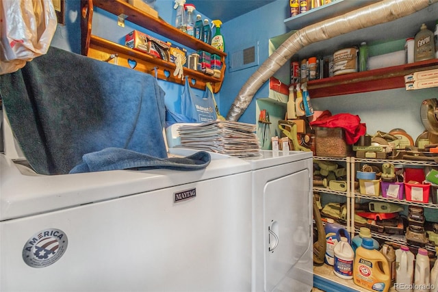 clothes washing area with washer and clothes dryer