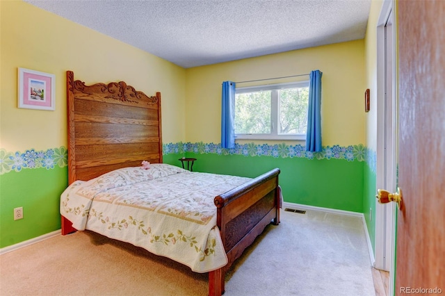 carpeted bedroom featuring a textured ceiling