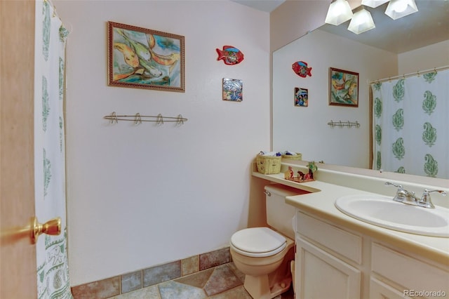 bathroom featuring vanity, tile patterned floors, and toilet