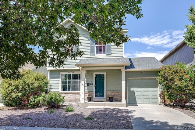 6330 Rockville Dr, Colorado Springs, CO 80923 - view of front facade with an attached garage, driveway, brick siding, and roof with shingles