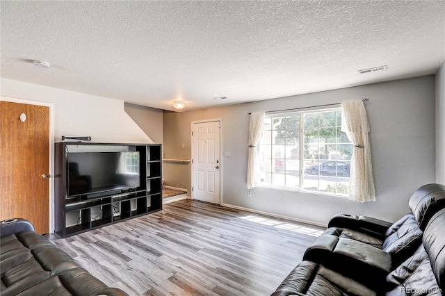 6330 Rockville Dr, Colorado Springs, CO 80923 - living area featuring wood finished floors and a textured ceiling
