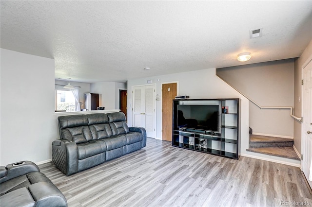 6330 Rockville Dr, Colorado Springs, CO 80923 - living area featuring wood finished floors and a textured ceiling