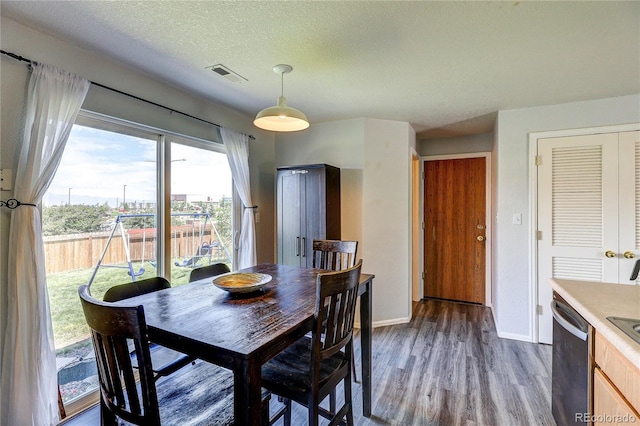 6330 Rockville Dr, Colorado Springs, CO 80923 - dining room featuring dark wood-type flooring and a textured ceiling