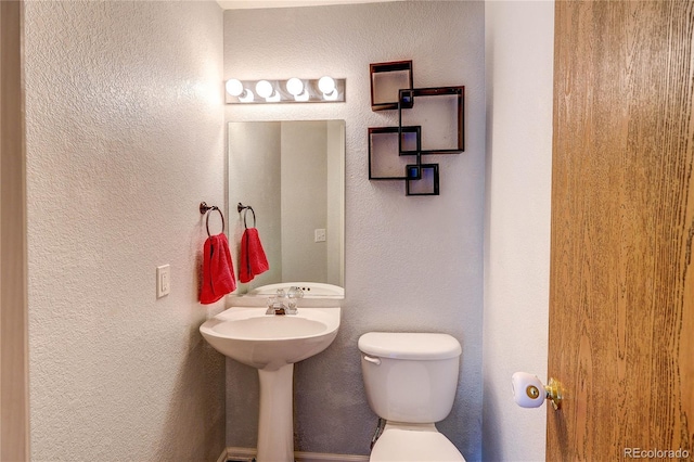 6330 Rockville Dr, Colorado Springs, CO 80923 - half bathroom with toilet and a textured wall