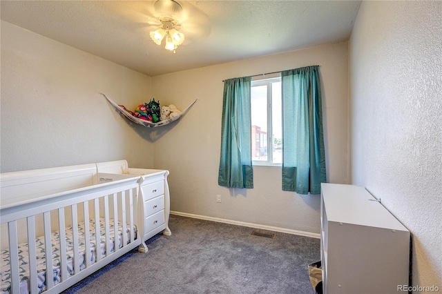 6330 Rockville Dr, Colorado Springs, CO 80923 - bedroom with carpet floors, a textured wall, and a crib
