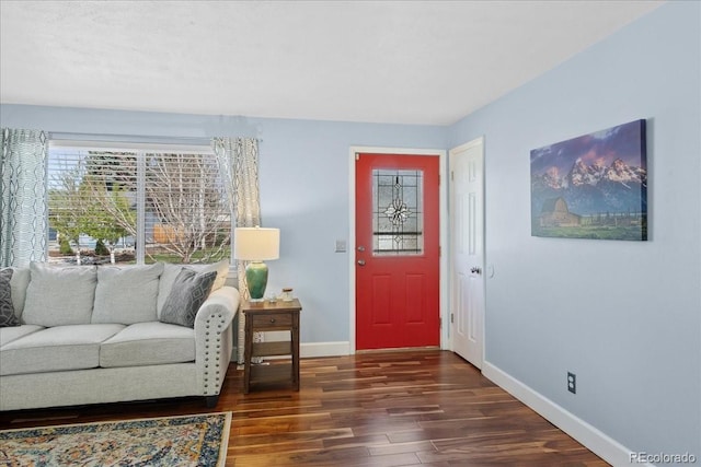 living area featuring baseboards and wood finished floors