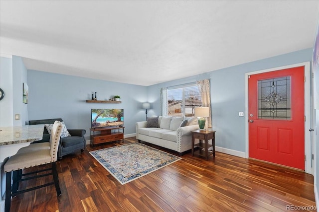 living area featuring baseboards and wood finished floors
