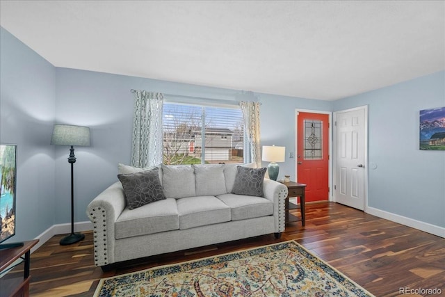 living area featuring baseboards and wood finished floors
