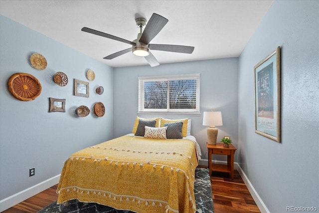 bedroom featuring baseboards, a ceiling fan, and wood finished floors