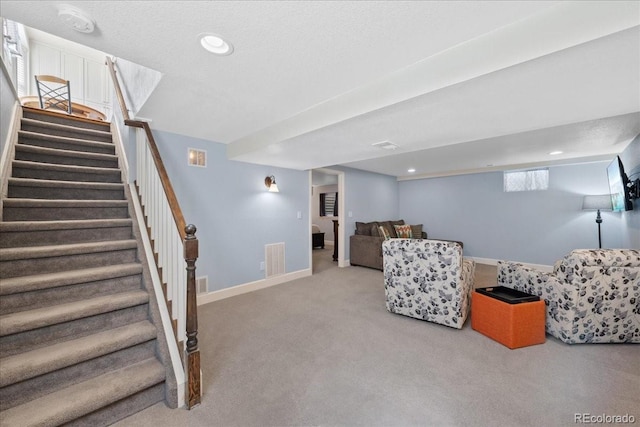 living area featuring visible vents, carpet, stairs, and recessed lighting