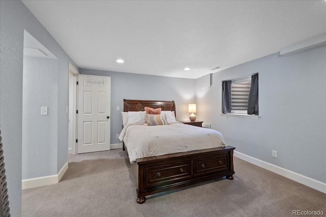 bedroom featuring light colored carpet, recessed lighting, and baseboards