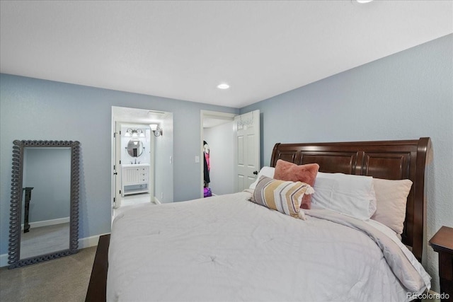 carpeted bedroom with connected bathroom, recessed lighting, and baseboards