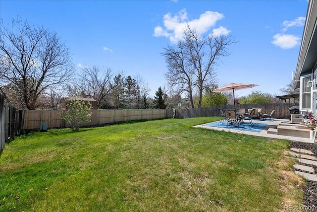 view of yard with a fenced backyard and a patio area