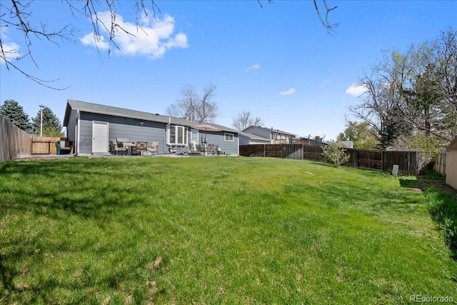 view of yard with a fenced backyard