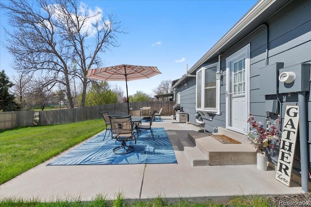 view of patio with outdoor dining area and a fenced backyard