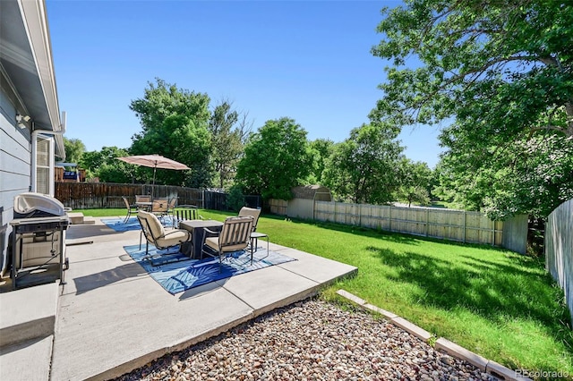 6074 S Dudley Way, Littleton, CO 80123 - fenced backyard featuring a patio area