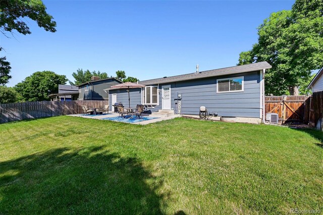 6074 S Dudley Way, Littleton, CO 80123 - rear view of house with entry steps, a patio, and a fenced backyard