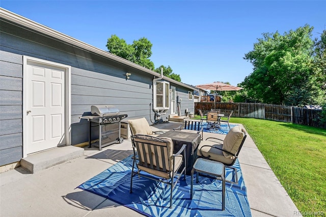 6074 S Dudley Way, Littleton, CO 80123 - fenced backyard featuring outdoor dining area, a grill, and a patio