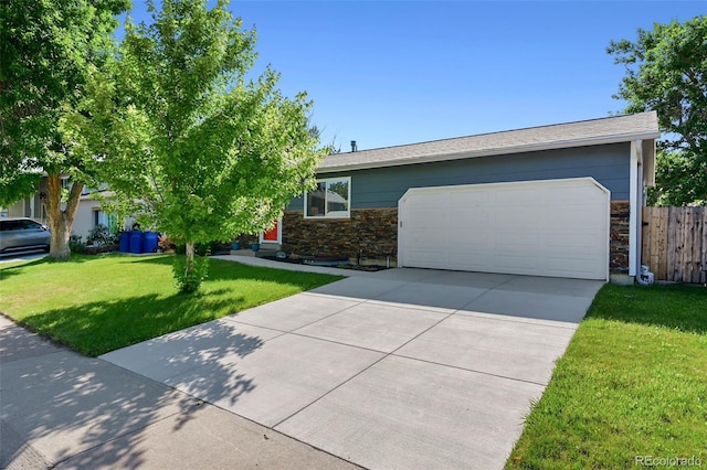 6074 S Dudley Way, Littleton, CO 80123 - view of front of property with stone siding, an attached garage, and driveway