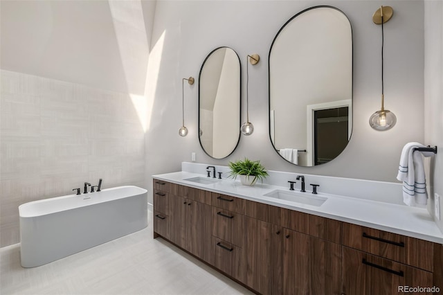 bathroom with a soaking tub and double vanity