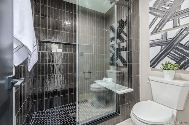 full bathroom featuring toilet and a shower stall