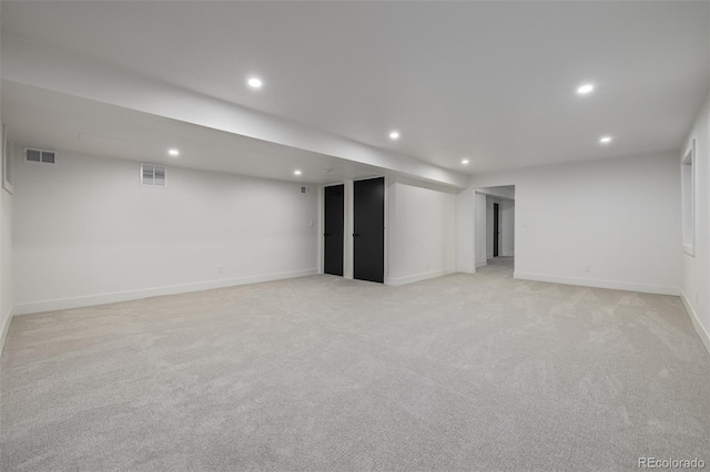 finished below grade area with recessed lighting, light carpet, and baseboards