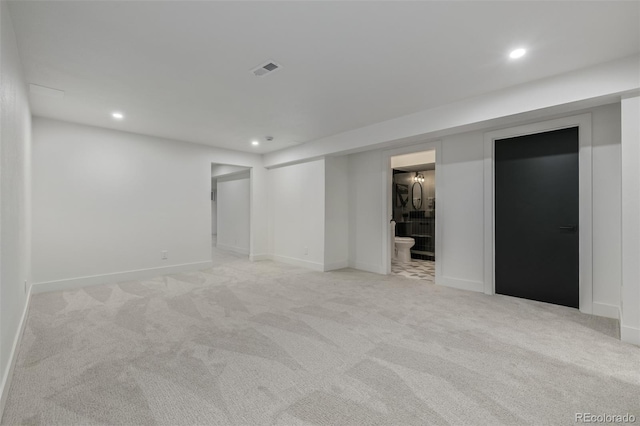 finished basement featuring recessed lighting, light colored carpet, and baseboards