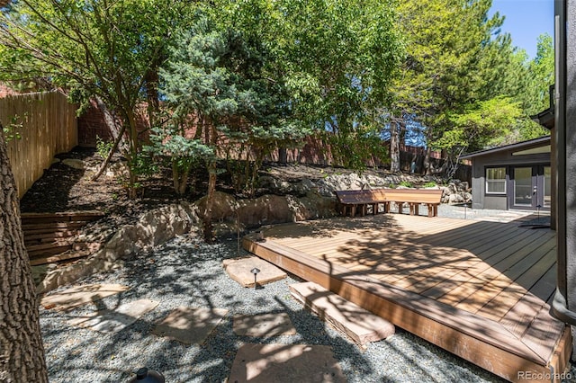 wooden terrace featuring a fenced backyard