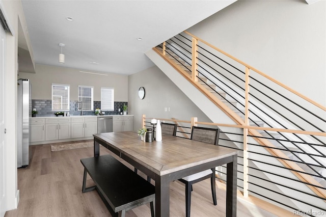 2620 S Delaware St Unit 2, Denver, CO 80223 - dining space with light wood finished floors, stairs, and recessed lighting