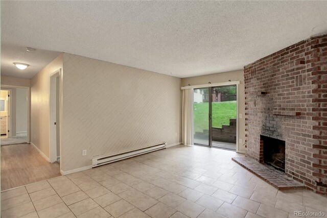 unfurnished living room with a textured ceiling, tile patterned flooring, baseboards, baseboard heating, and a brick fireplace