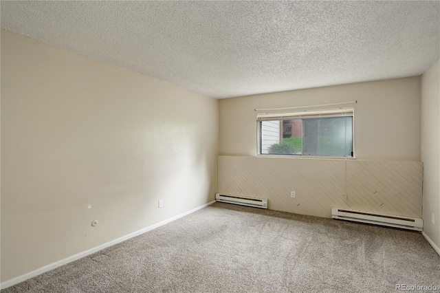 unfurnished room with a baseboard heating unit, carpet floors, and a textured ceiling