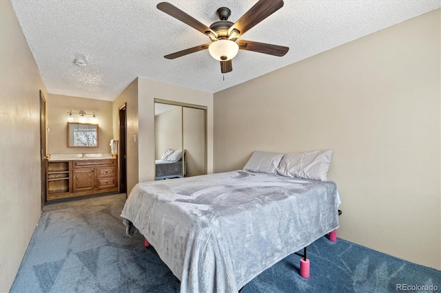 bedroom with a closet, ceiling fan, a textured ceiling, light carpet, and ensuite bathroom