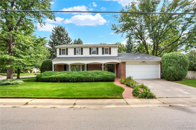 view of front of home with a garage and a front lawn