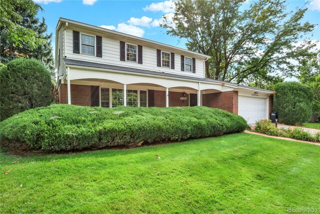 view of front of home featuring a garage and a front lawn