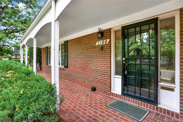 view of exterior entry featuring a porch