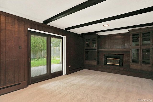 unfurnished living room with a brick fireplace, beamed ceiling, a baseboard radiator, and wood walls