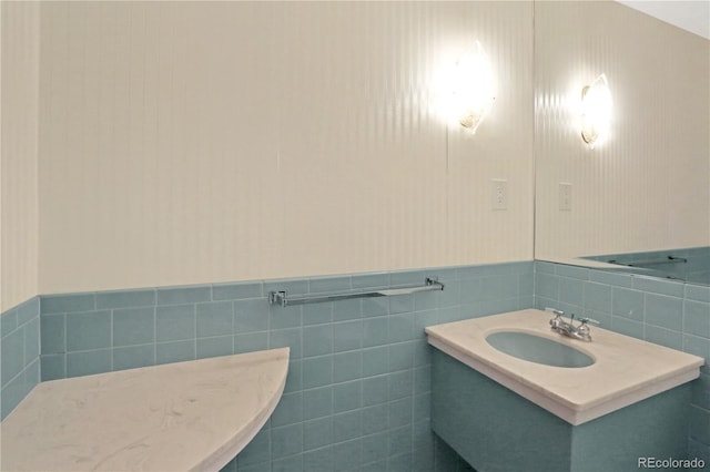 bathroom with tile walls and vanity