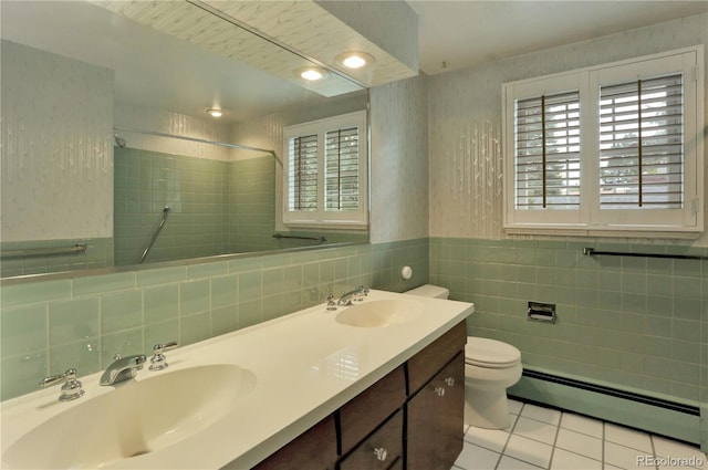 bathroom featuring vanity, toilet, tiled shower, baseboard heating, and tile patterned flooring