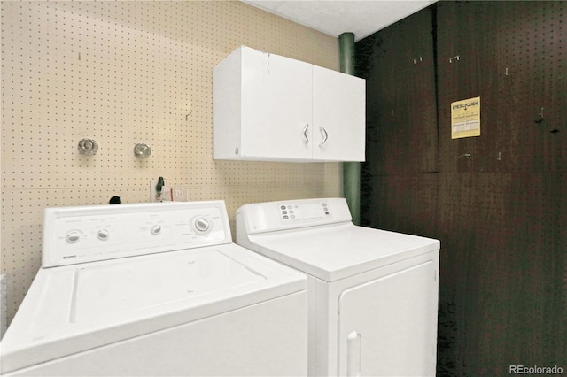 laundry area featuring cabinets and washing machine and dryer