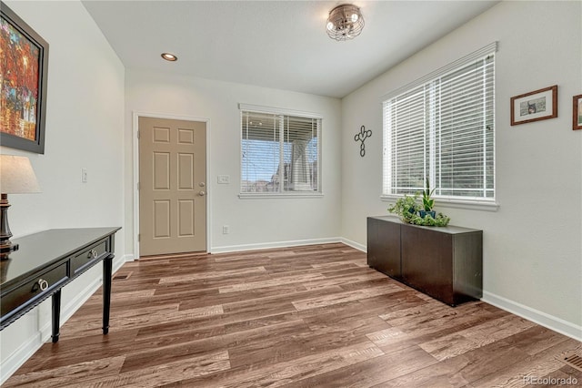 foyer featuring recessed lighting, baseboards, and wood finished floors